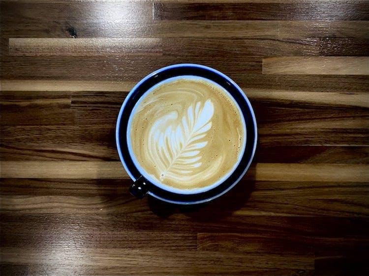 cafe1 latte with nice latte art on a wooden table