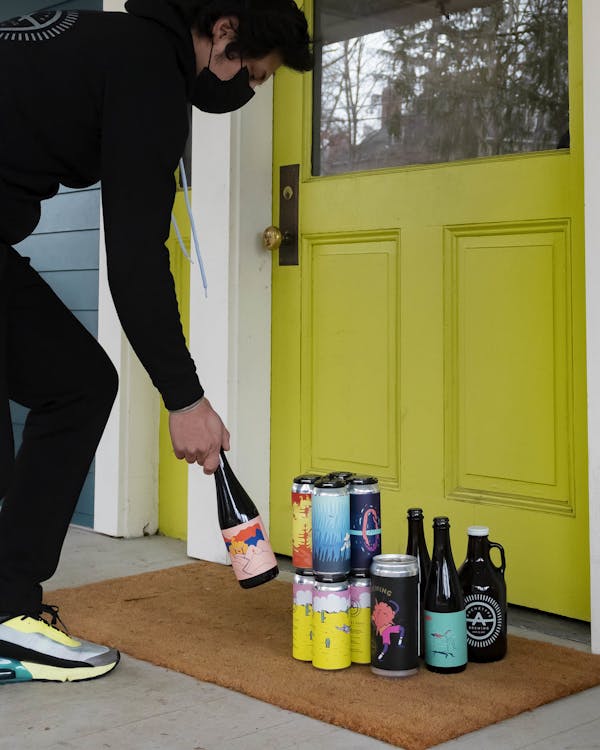 2021_Archetype Brewing - JPG- Front Door Delivery -4- carlos maldonado romero person delivering beer, welcome mat, front door