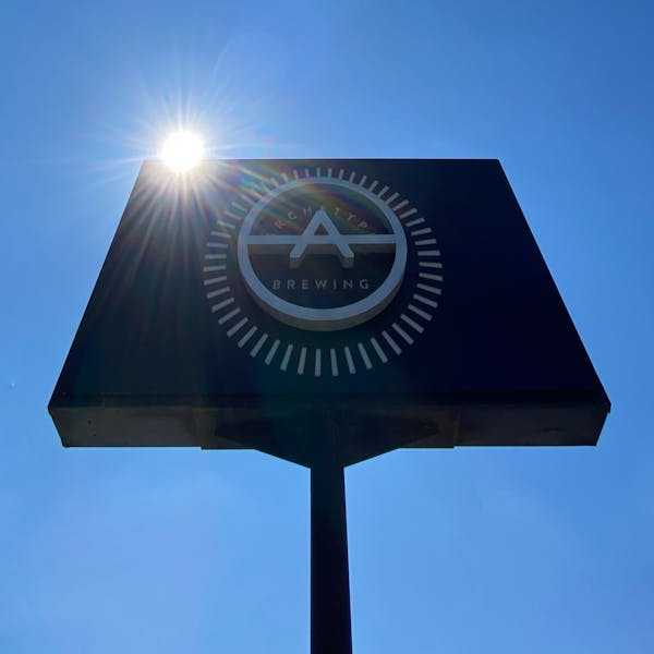 Archetype Brewing Sign with sun and blue skies