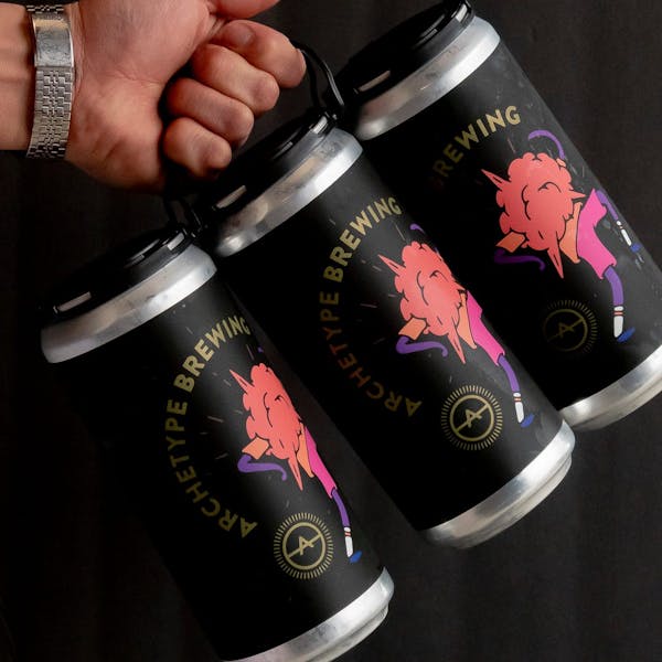 three pack crowler cans being held by a hand