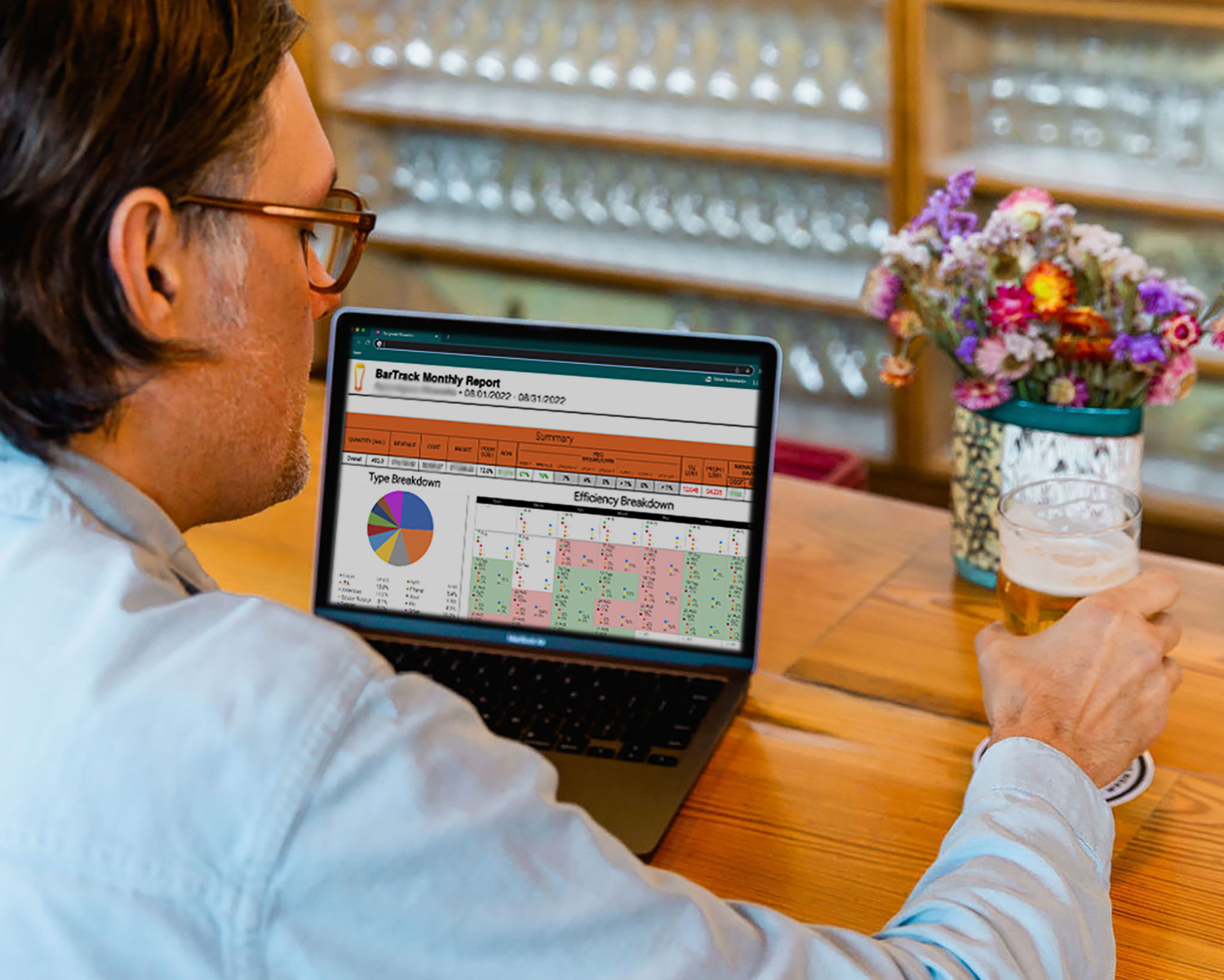 person sitting at a bar working on a computer