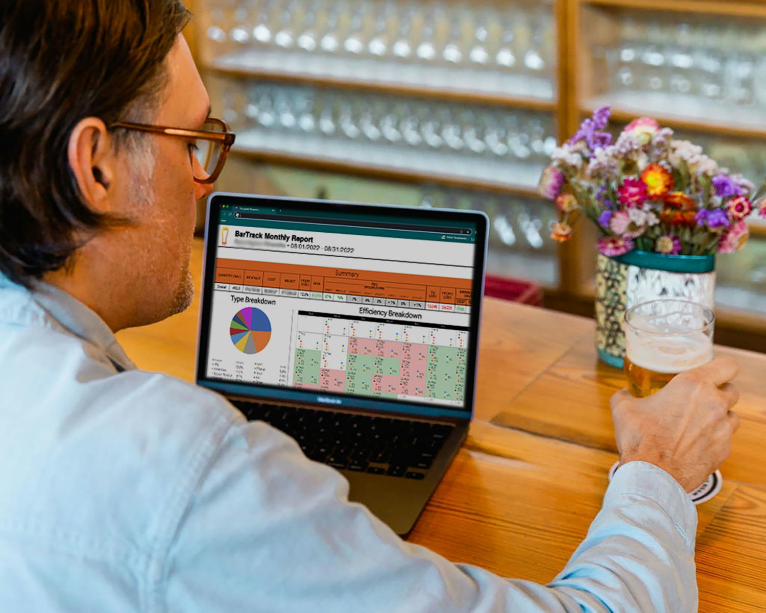 person sitting at a bar working on a computer