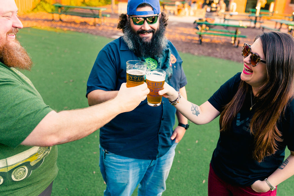 Guests enjoy beer outside on a lawn
