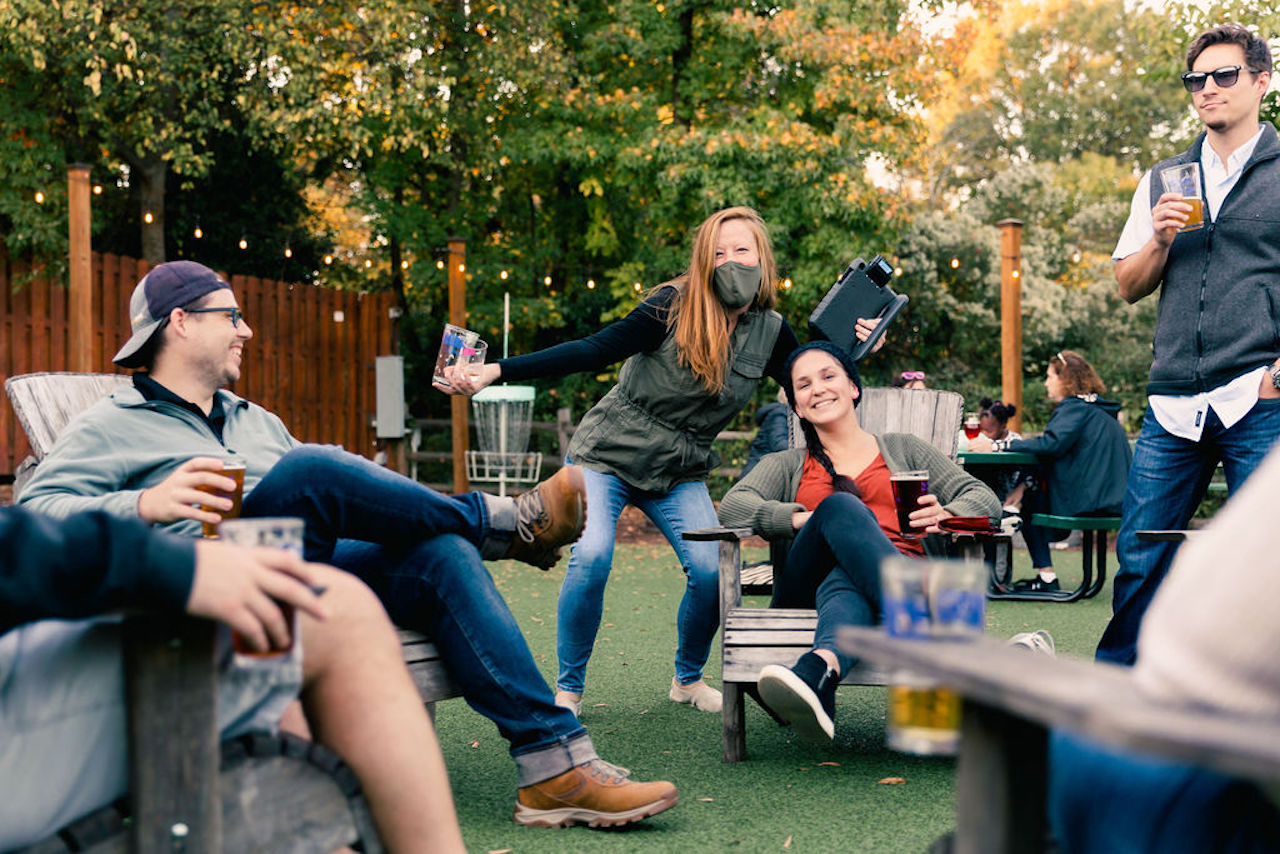 a group of guests enjoying beers outside 