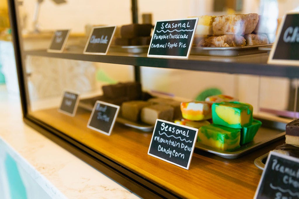 wooden shelves with products and small chalkboard signs