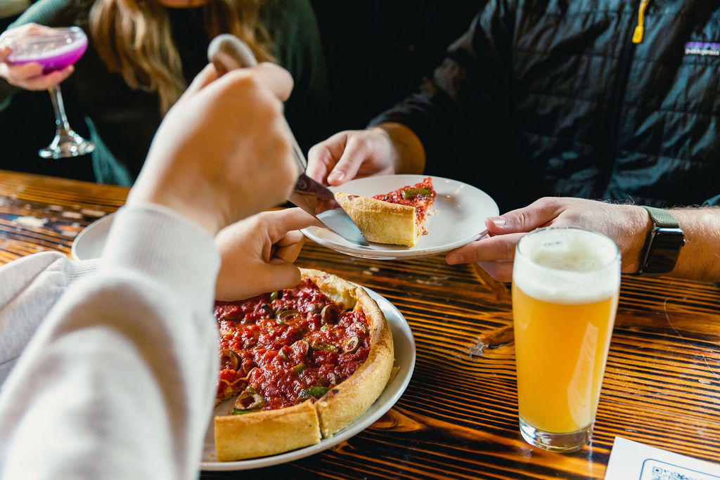 guests eating pizza and drinking beer