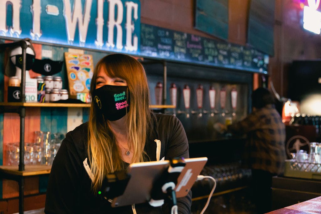 A bartender uses the Arryved POS on a tablet