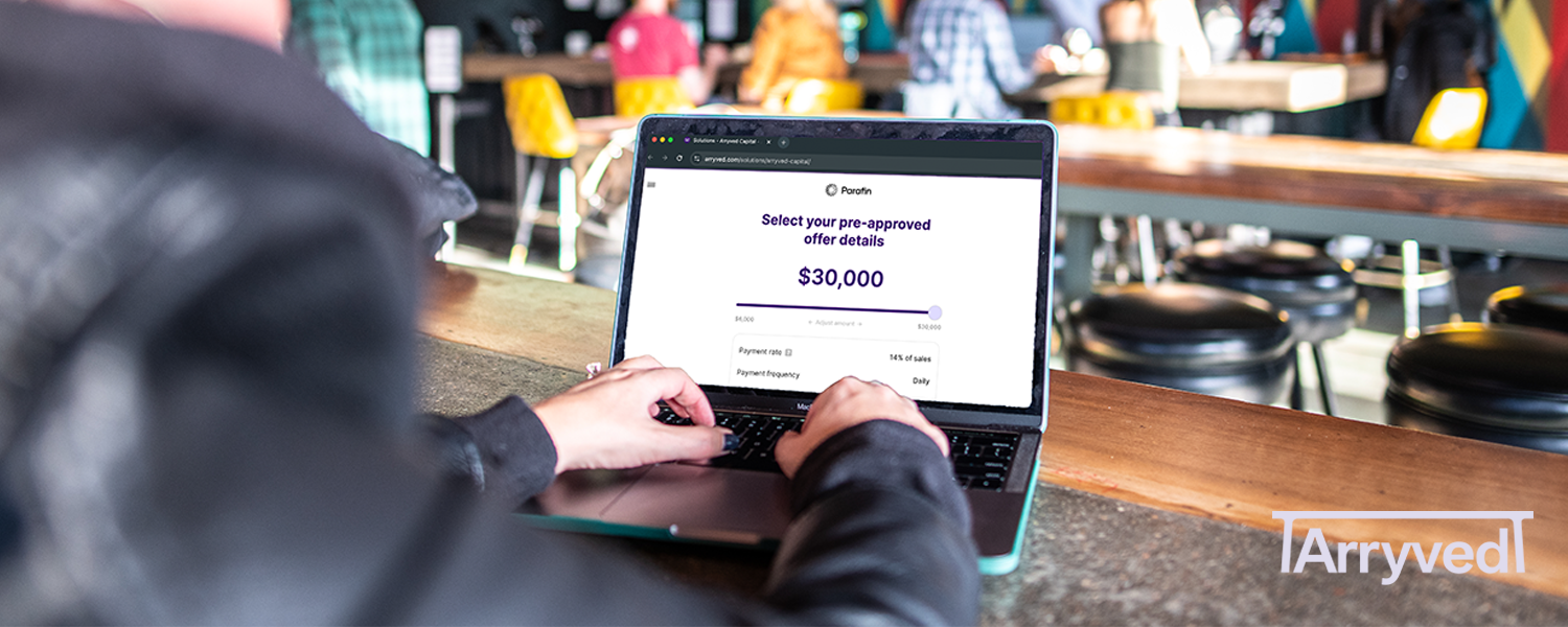 a person uses a laptop at a bar