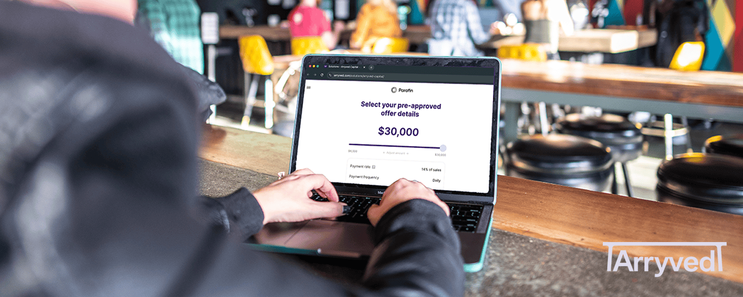 a person uses a laptop at a bar