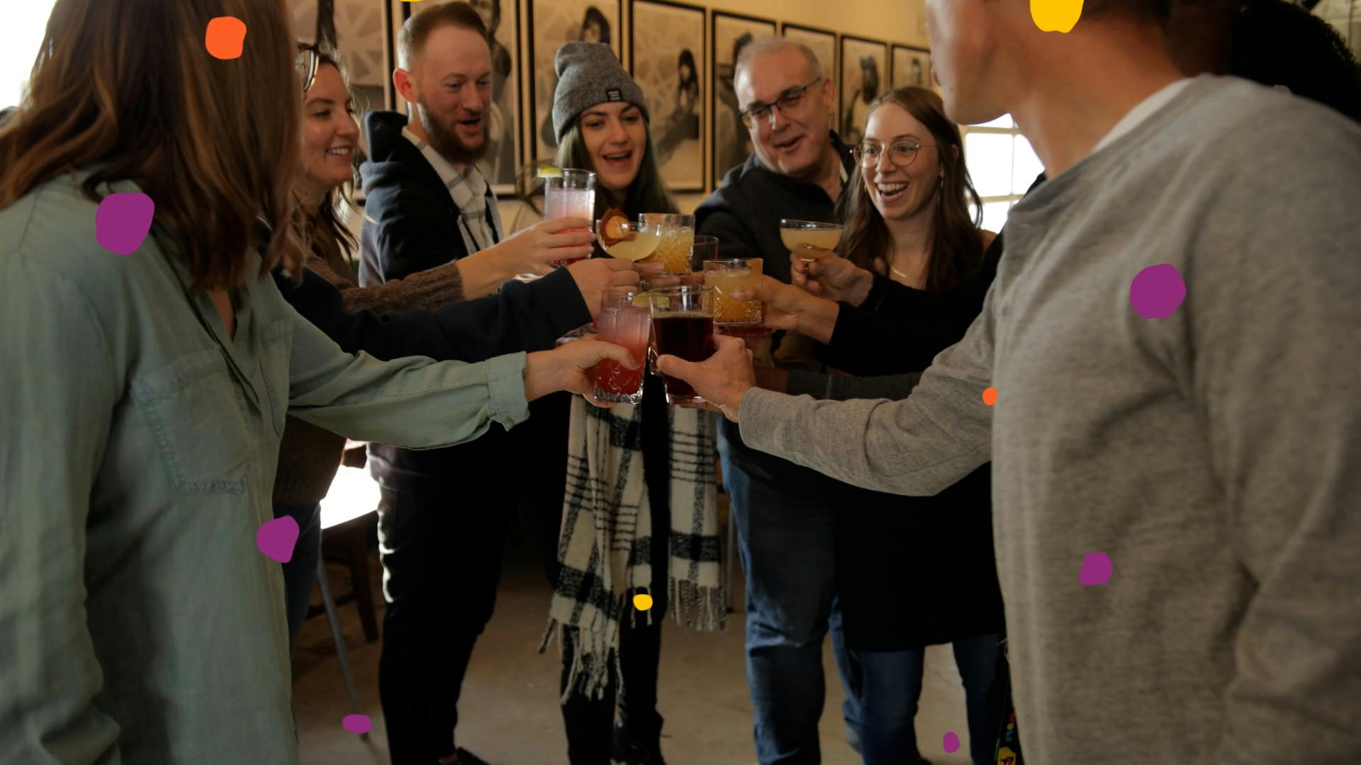 group of people raise their glasses in the center of where they stand