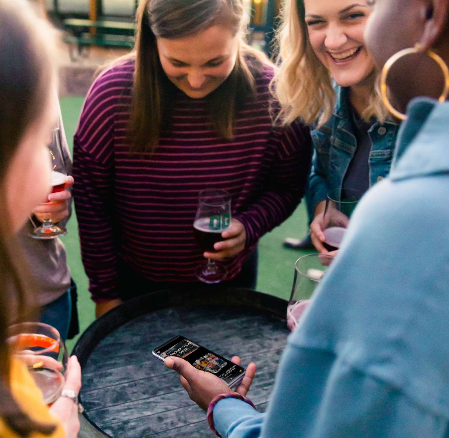 a group of guests enjoy beers outside