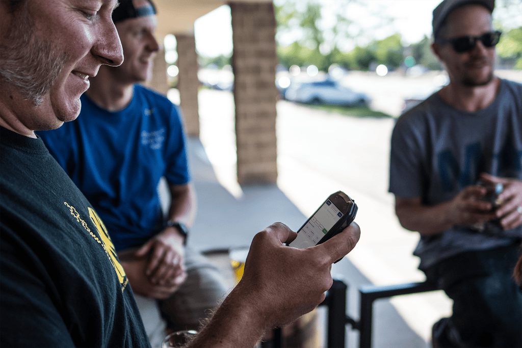 A guest uses he BevFinder on their phone at a taproom