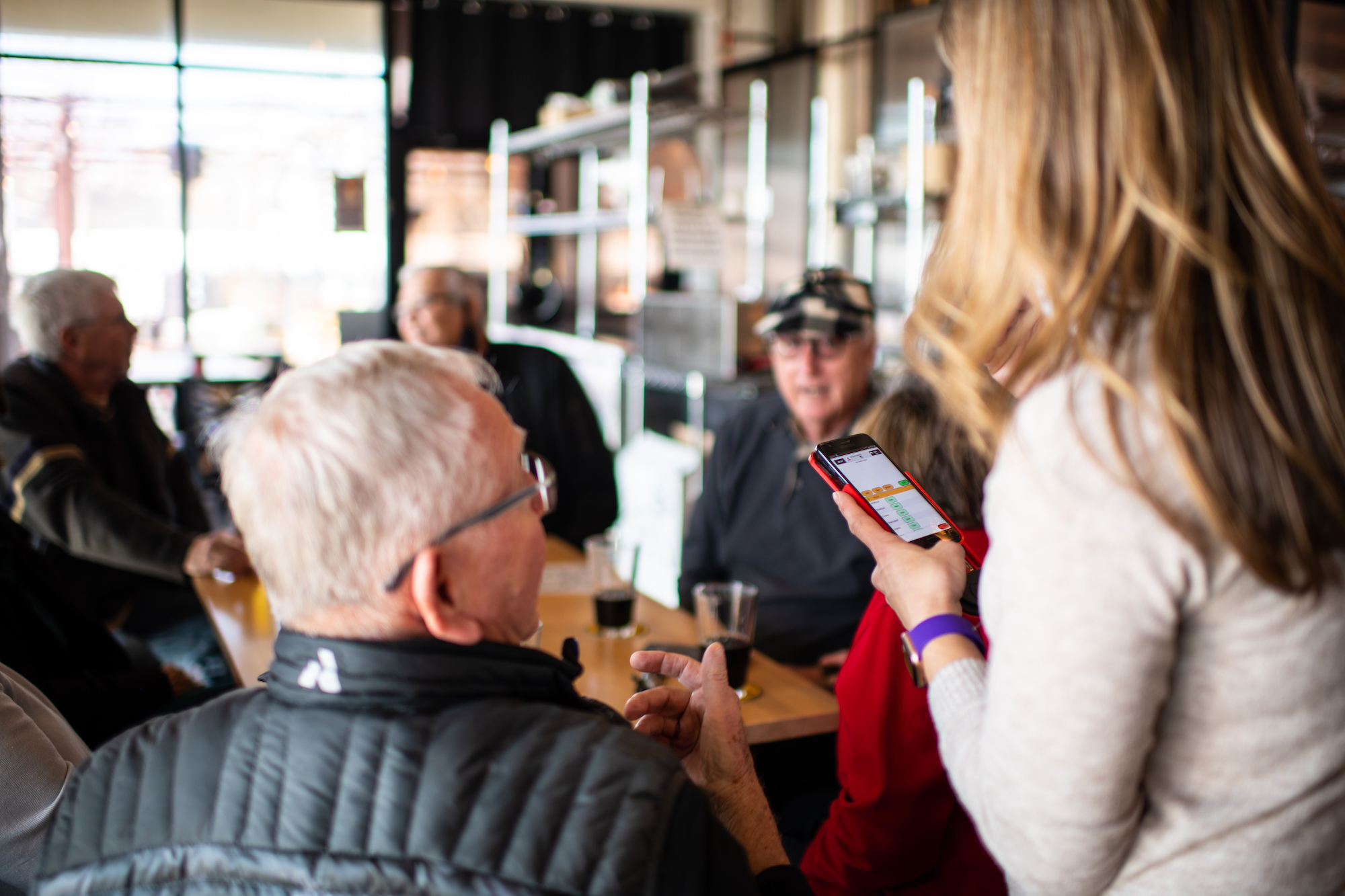 staffing challenges webinar photo - a group of people stand at a bar waiting to order