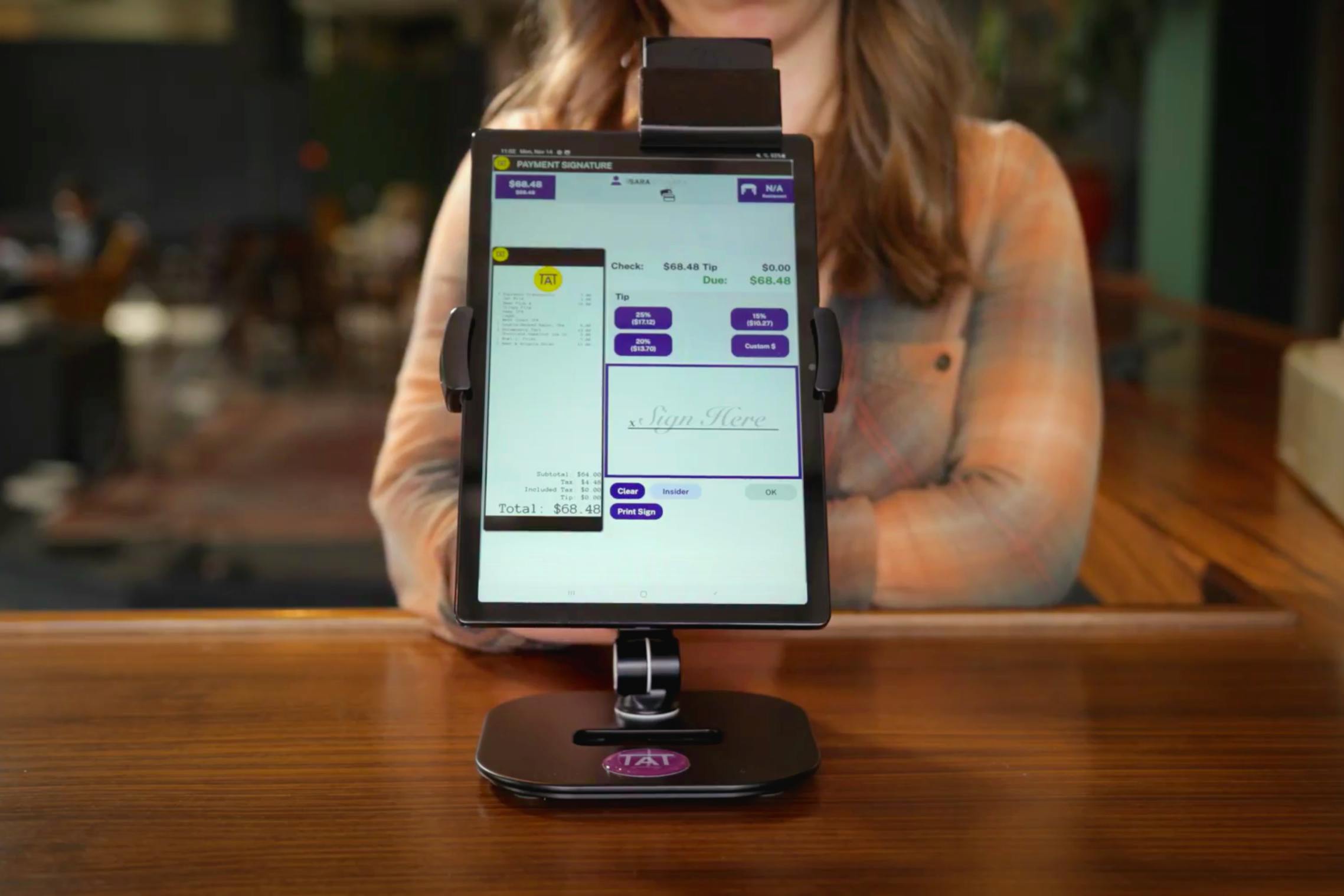 a bartender uses an Arryved POS tablet