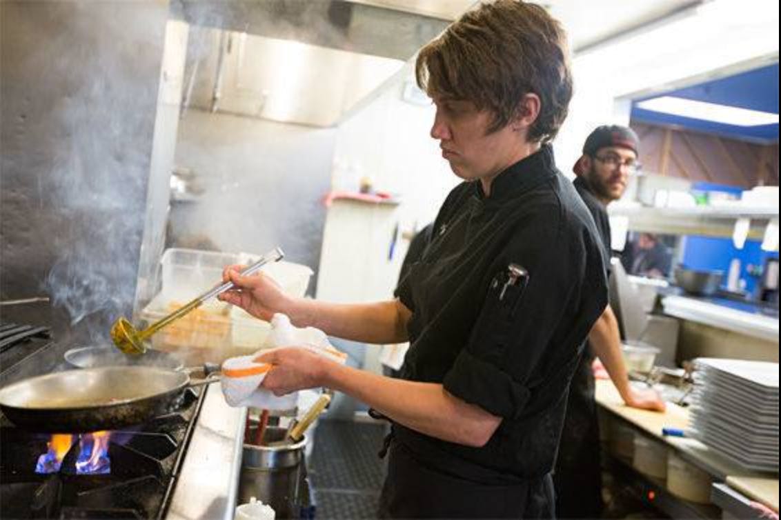 kitchen staff prepares food in a kitchen