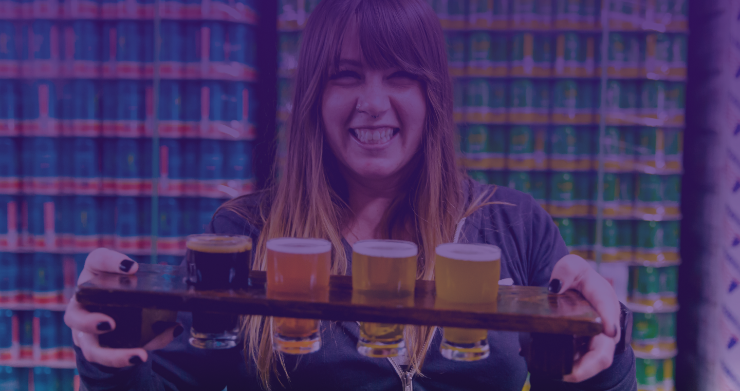 Woman holding flight of craft beer