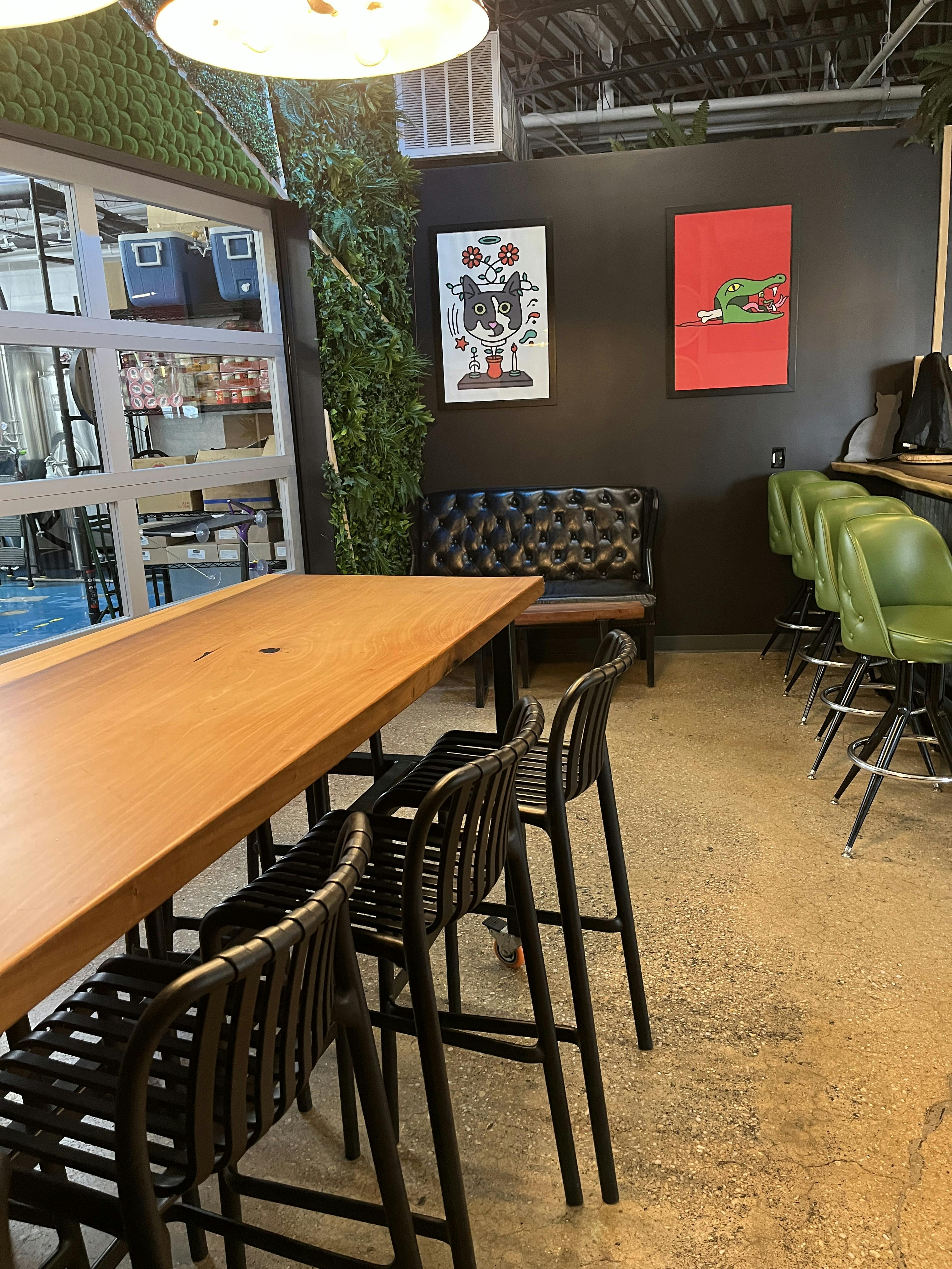 00D609A5-297E-47AC-BEBA-A5288A359A09 Interior photo of Babycat taproom with table and chairs