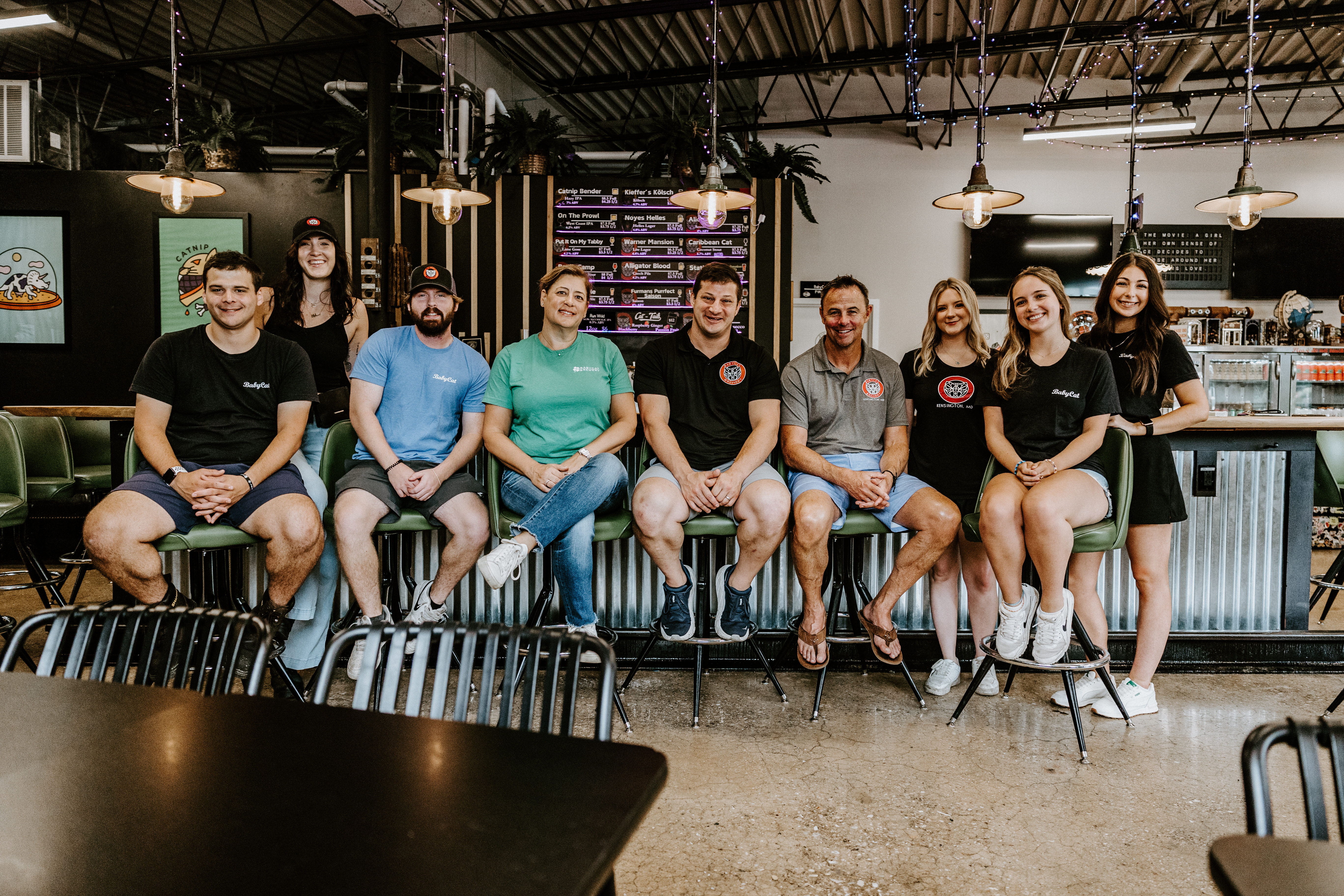 babycat staff members seated at taproom bar