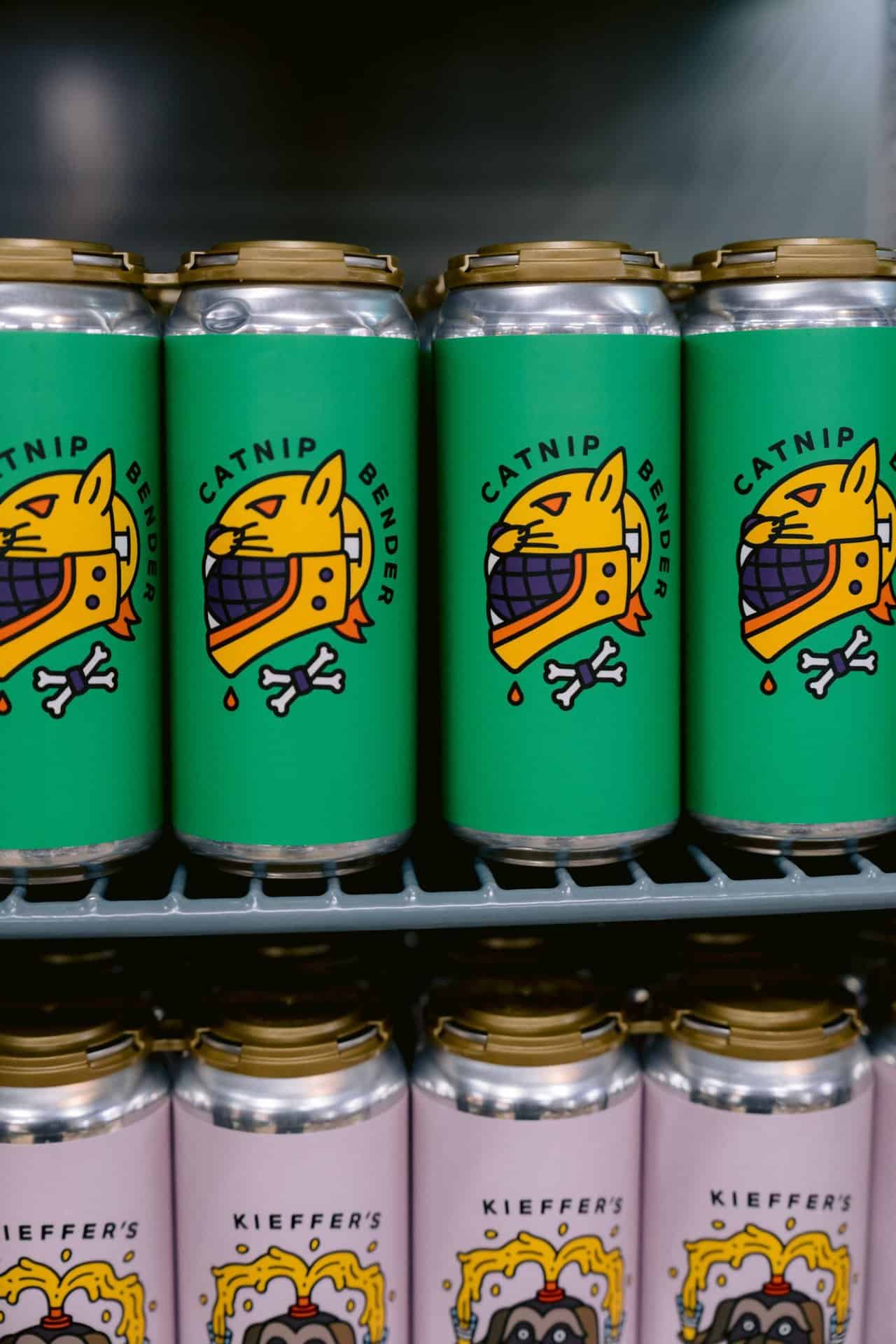 Line of green Babycat cans on a shelf