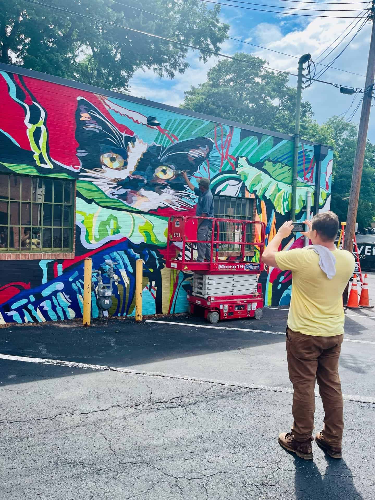 colorful mural on the side of babycat taproom building