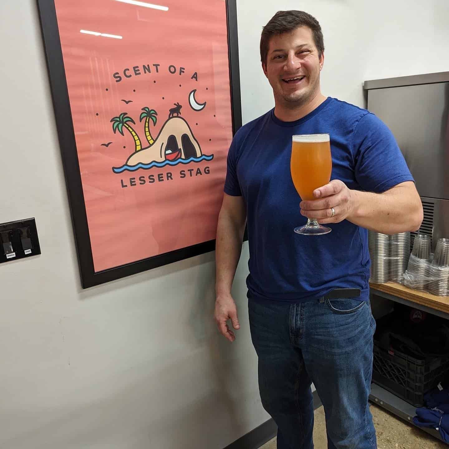 Babycat owner, Sam, holds a beer