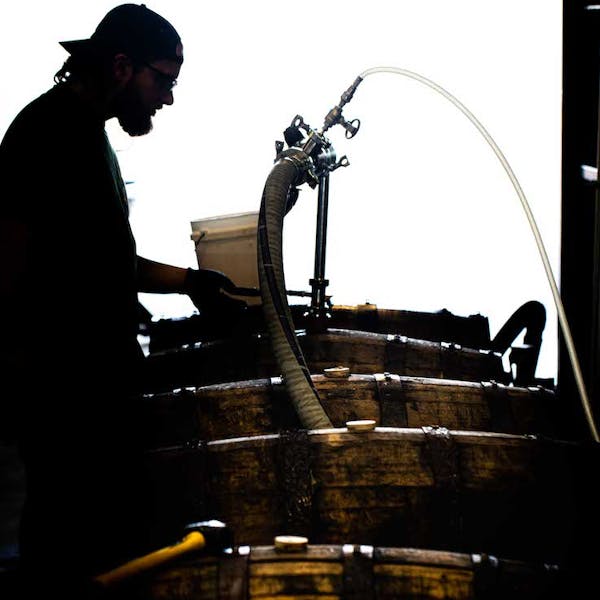 Man filling barrels