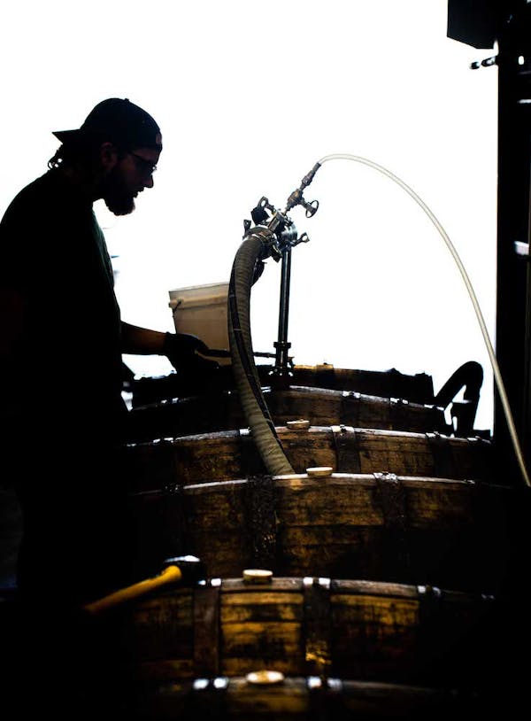 Angels (1 of 1) Man filling barrels