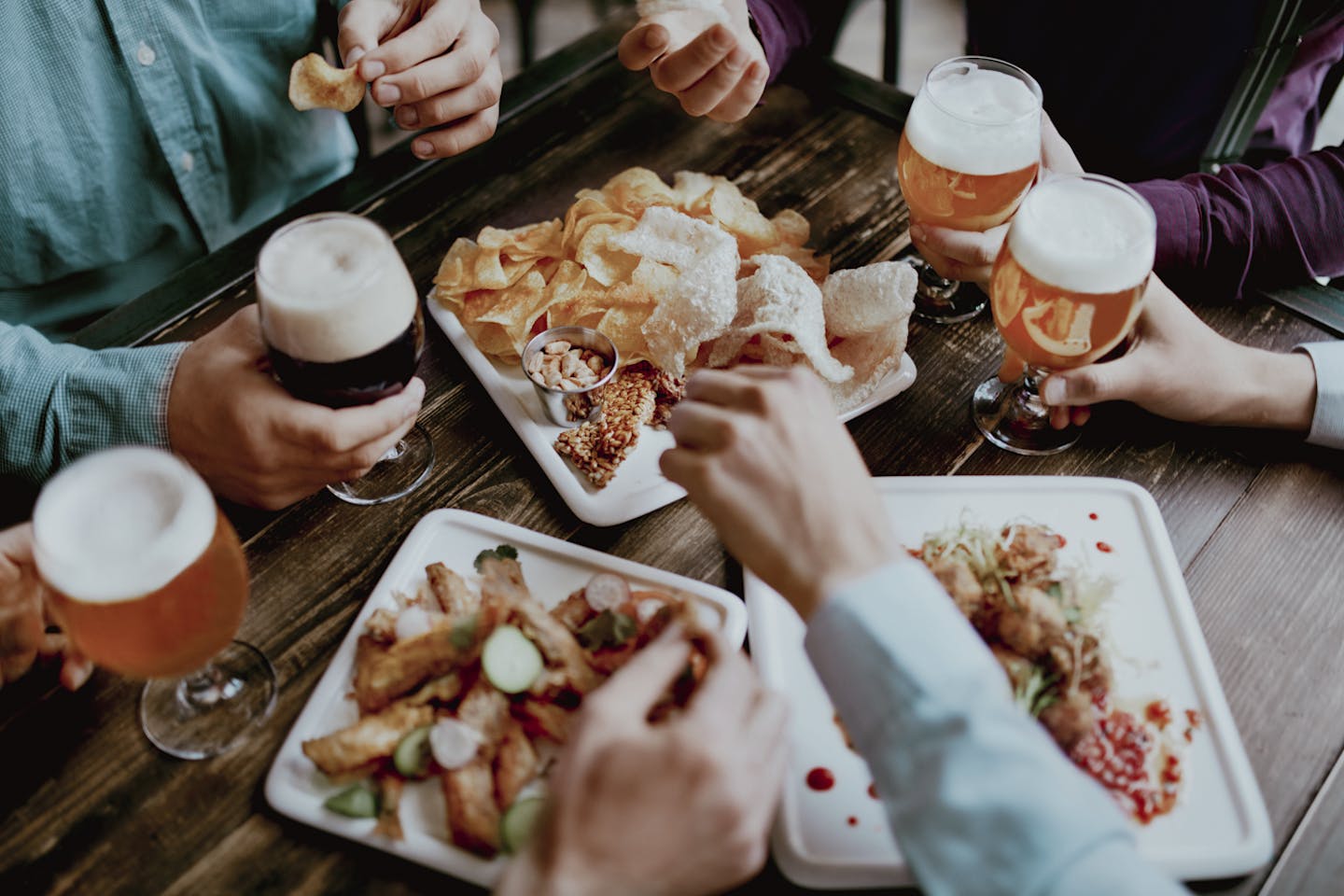Men Drinking Beer And Eating Snacks, Tasty Food Closeup In Pub Restaurant. High Resolution.