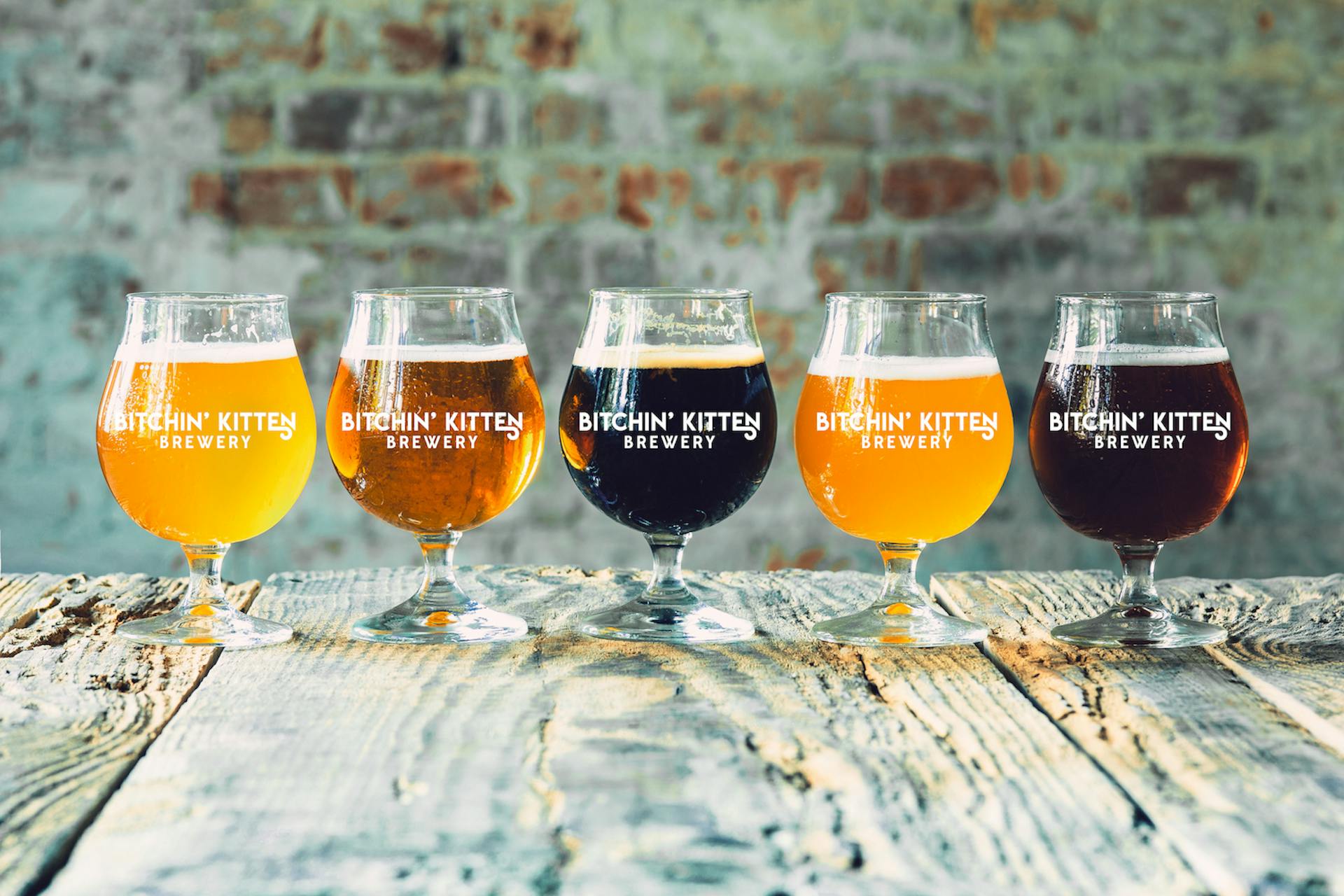 Glasses of different kinds of beer on wooden background Glasses of different kinds of beer on wooden background
