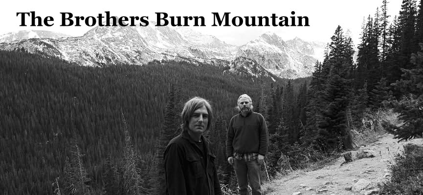 black and white photo, mountains in the back and 2 men