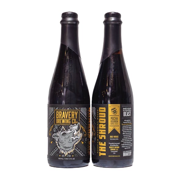 two bottles of The Shroud mocha bourbon barrel-aged beer, the left bottle showing the front label art, the right showing the label details