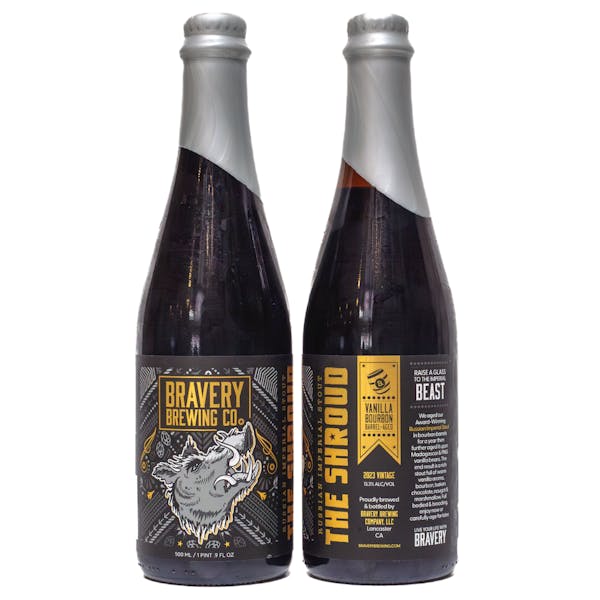 two bottles of The Shroud vanilla bourbon barrel-aged beer, the left bottle showing the front label art, the right showing the label details