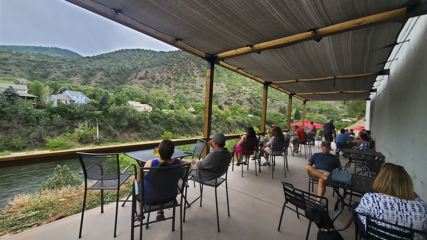 People drinking Casey Brewing sour beer by the river