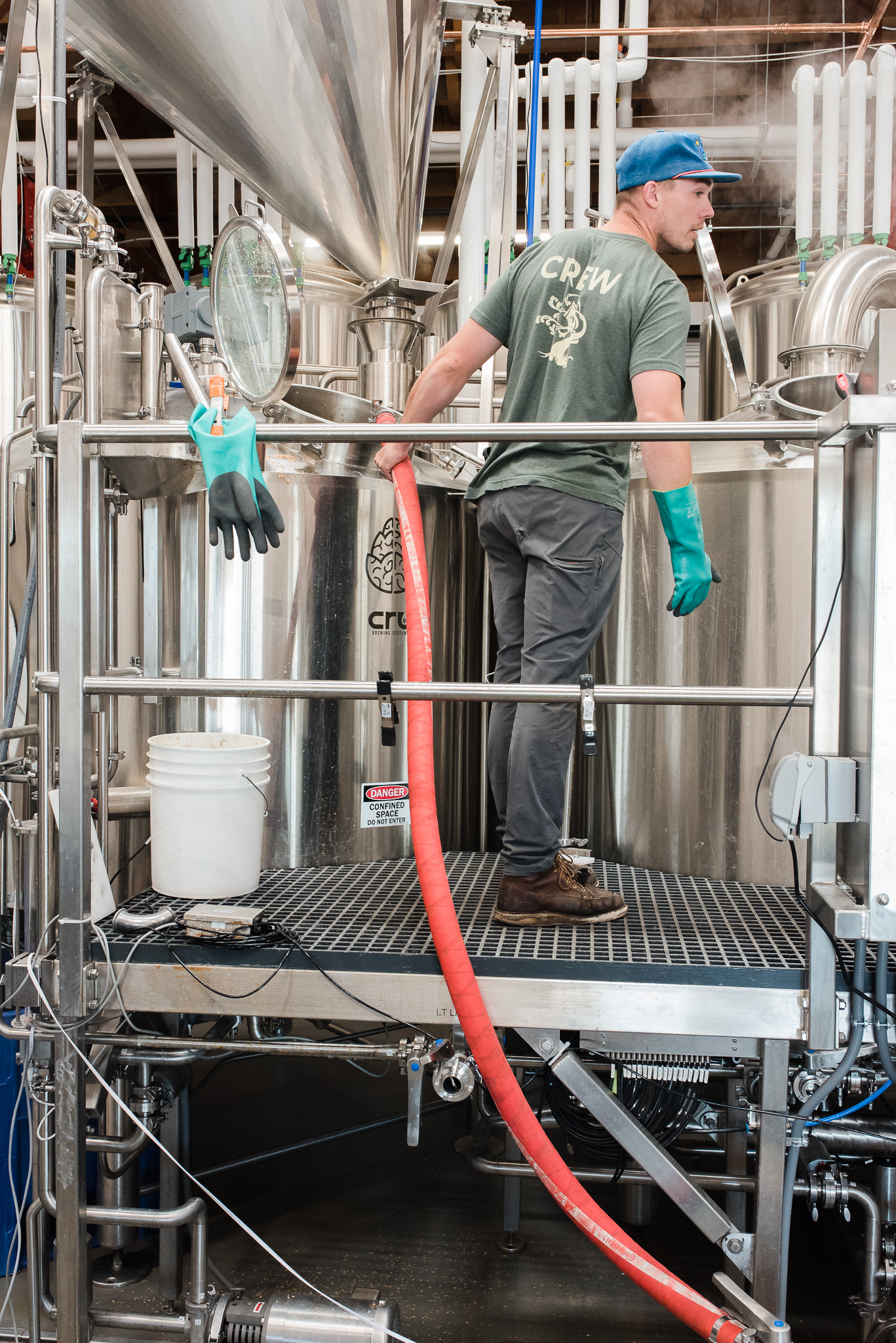 Brewer pumping wort back to mash tun from kettle