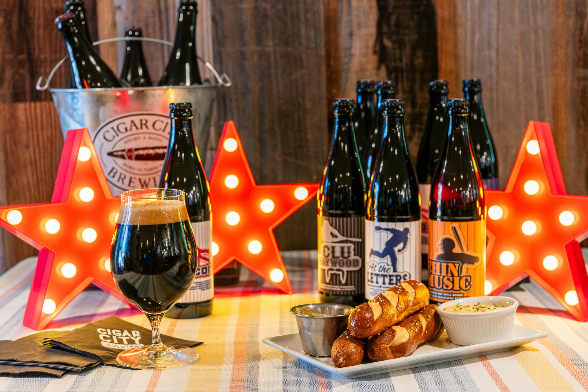 TaproomEventSpace-02 Cigar City beers with plate of pretzels and red, lit-up star decorations on a table