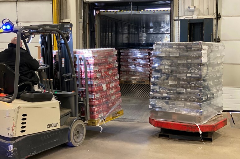 A man loading a stack of beer 