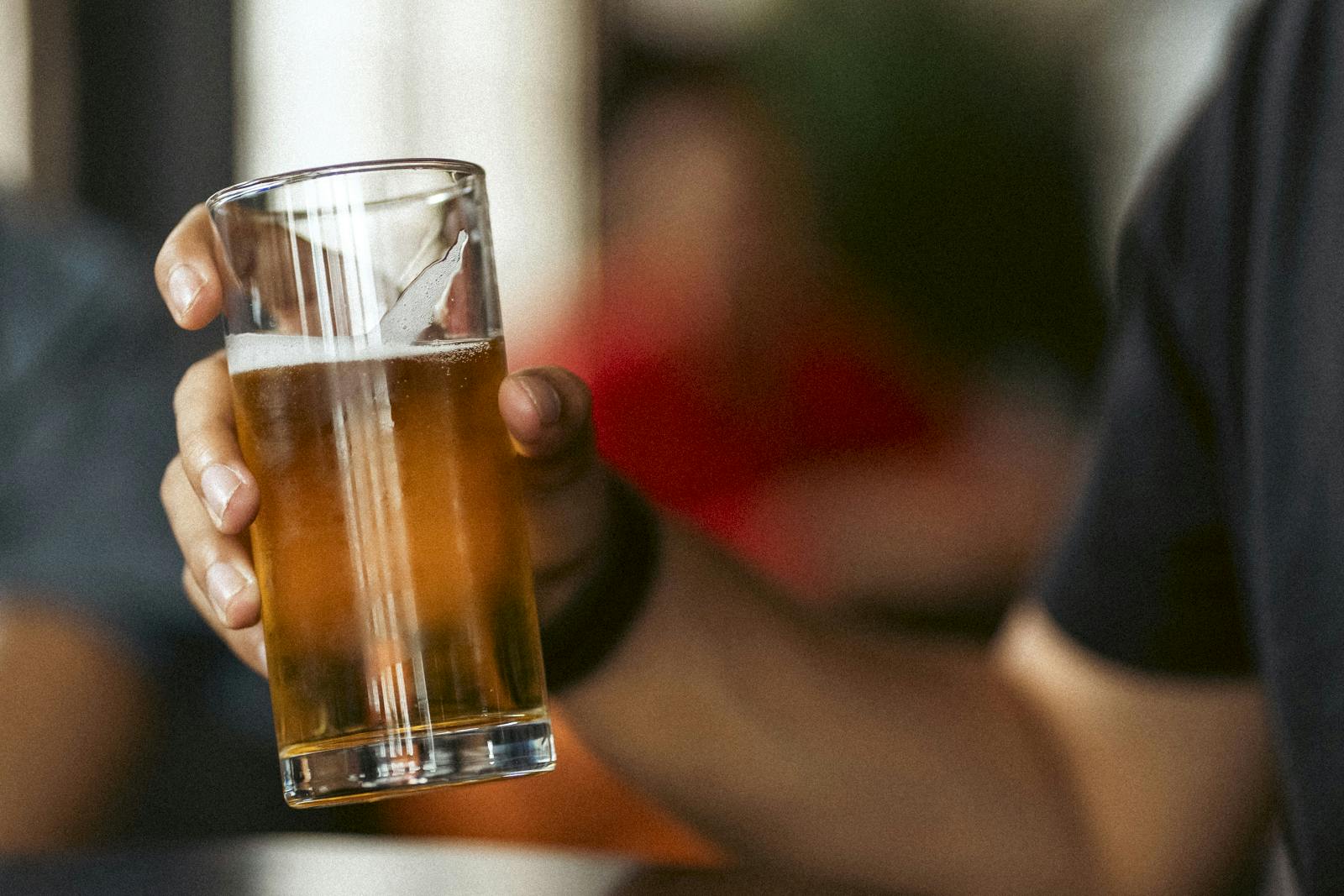 Hand holding a pint of beer