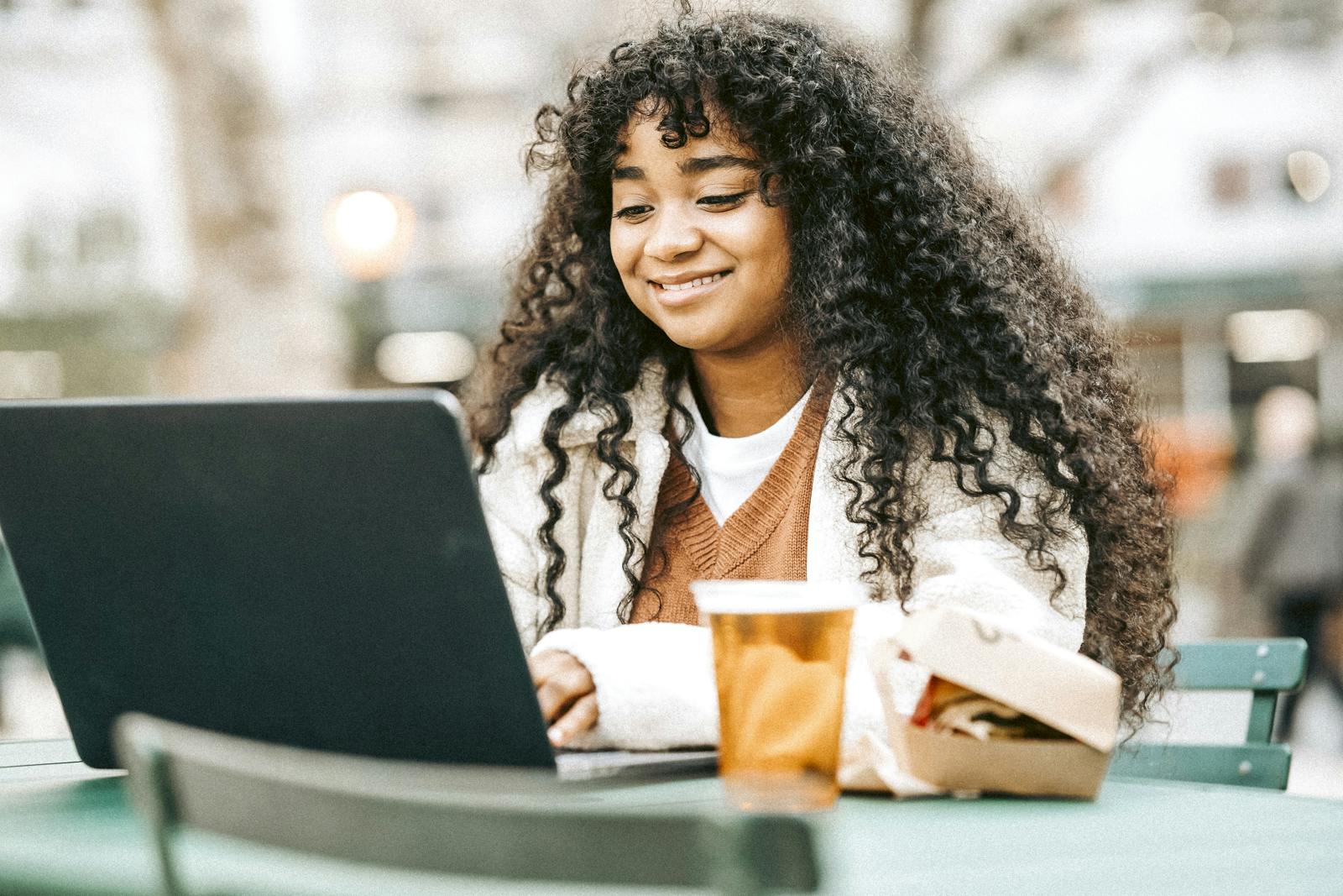 Photographer Woman working on a computer with a pint of beer