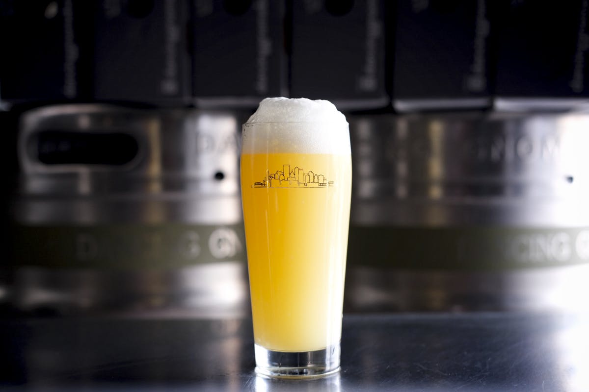 beer pint in front of kegs