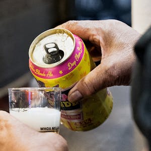 Pouring Deep Ellum Brewing Co.'s Dallas Blonde Golden Ale into a tasting glass at a Texas craft beer festival.