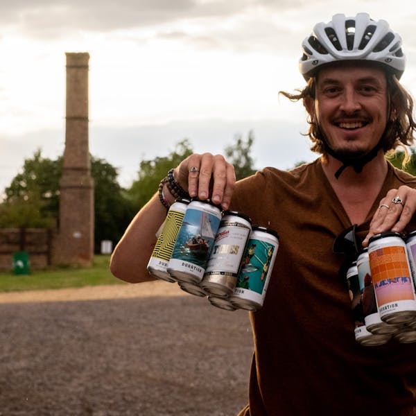Damien Gabet loads up for later with take away beers from Duration Brewing. The brewery sits not far off the Rebellion Way in Norfolk and is a Cycle Friendly Place, September 05 2022. Cycling UK's Rebellion Way is funded by the EU Regional Development Fund's EXPERIENCE project designed to help promote off-season tourism.