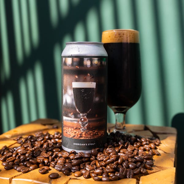 dark beer in glass with coffee beans