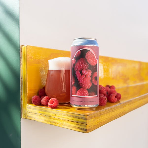 pink colored berliner with raspberries and a can