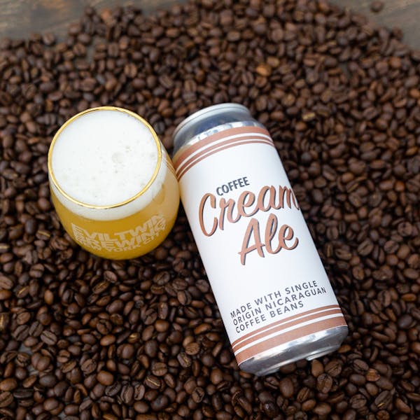 coffee beans surrounding glass of cream ale