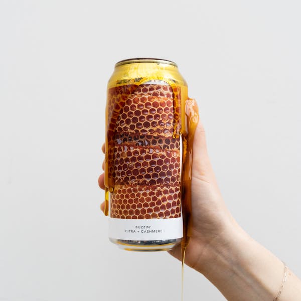 honey dripping down can of beer