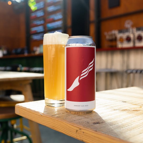 hazy pale ale in glass with can
