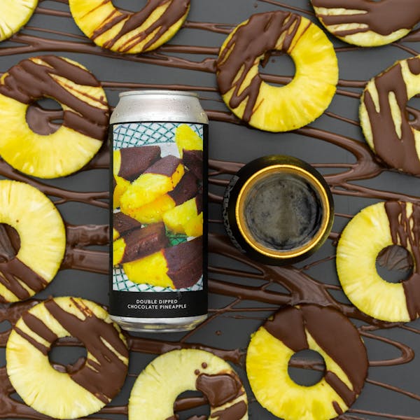 dark beer in glass on table with pineapple rings