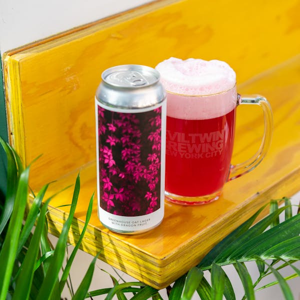 pink beer in glass on table