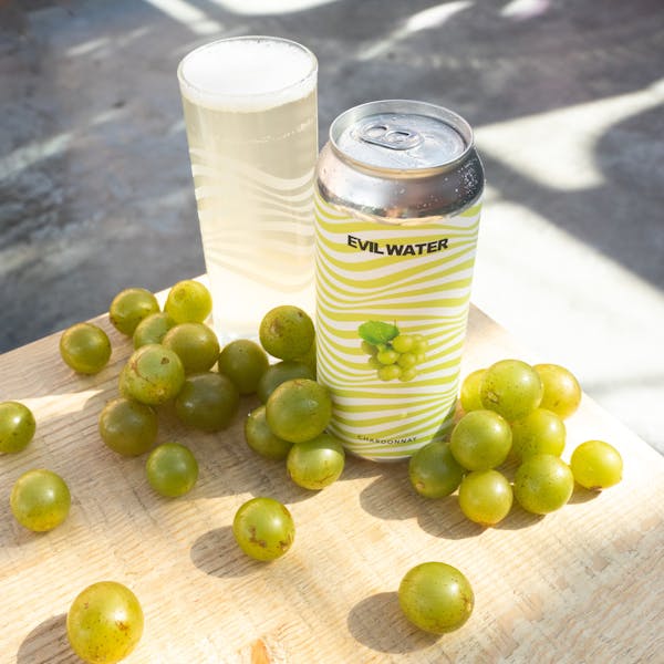 light green seltzer in glass on table