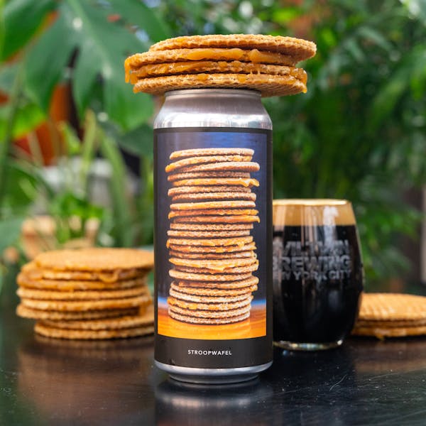 dark beer in glass on table with stroopwafel